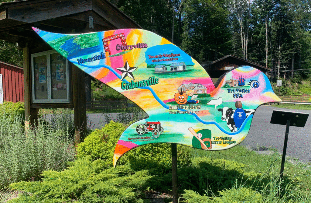  Painted with cheerful imagery of livestock, farm produce, blue ribbons, and a classic Ferris wheel, the dove highlights local traditions and community pride. It honors the contributions of the Tri-Valley FFA and Sullivan County 4-H, reflecting the region’s strong agricultural heritage.